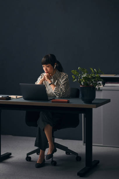 istock A Serious Beautiful Asian Teacher With Earbuds Working In The Office On Her Computer 1883303257