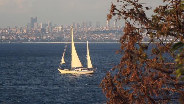 Sailing ship under full sail out Heybeliada Island coast in Marmara Sea. Three masted sailboat sailing into open sea