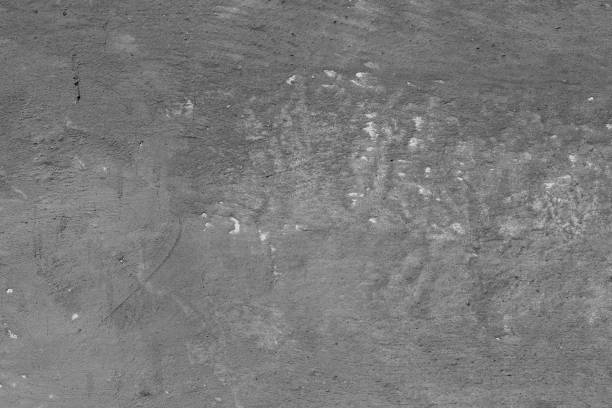 istock Light grey concrete wall with deep scratches and chips. Various variations of abrasions. 1883378134