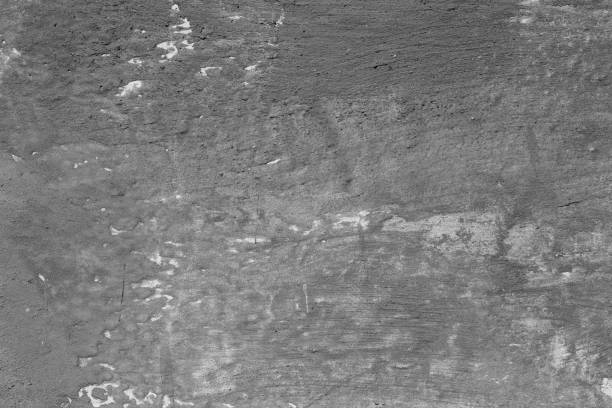 istock Light grey concrete wall with deep scratches and chips. Various variations of abrasions. 1883378638