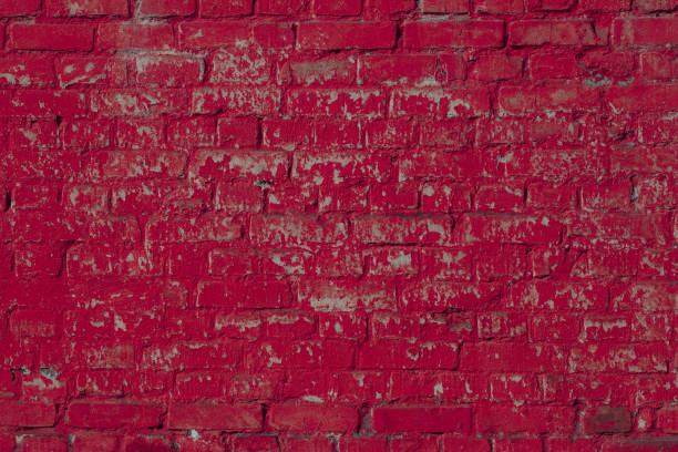 Horizontal brickwork of rough bricks. Fragment of a textured wall with natural long-term damage.