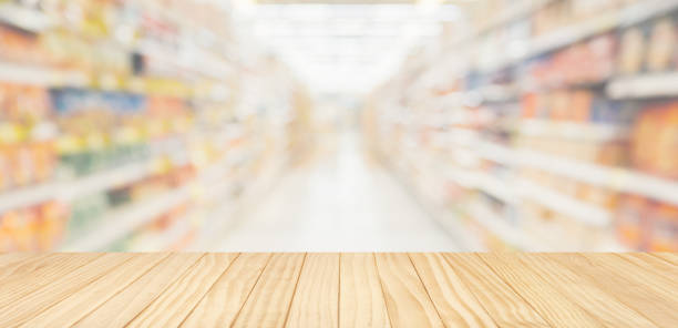 istock Empty wood table top with supermarket blurred background for product display 1883397230