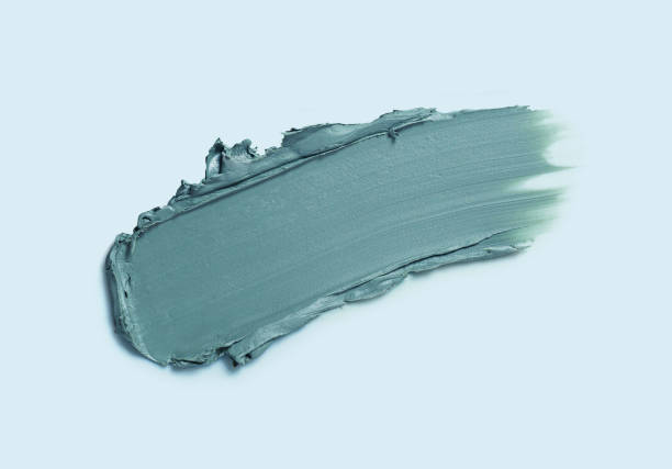 istock Cosmetic smeared creamy liquid blue gray eye shadow or liner swatch on blue background 1883401417