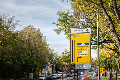 Picture of a german roadsign indicating various directions, notably the way to a german motorway and the way to the netherlands in Vaals.