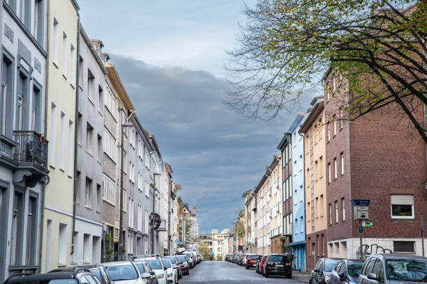 typical residetial street with multistorey residential buildings in a suburban street of aachen, germany, in a western european background. - aachen brick building exterior built structure imagens e fotografias de stock