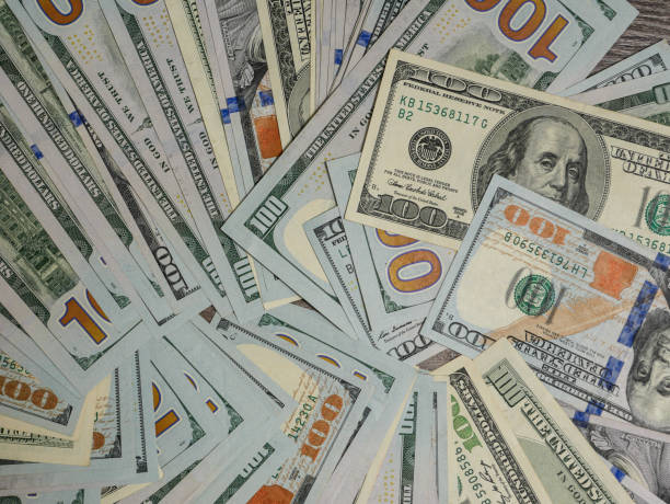 istock Background of 100 dollar bills, top view. 1883408666