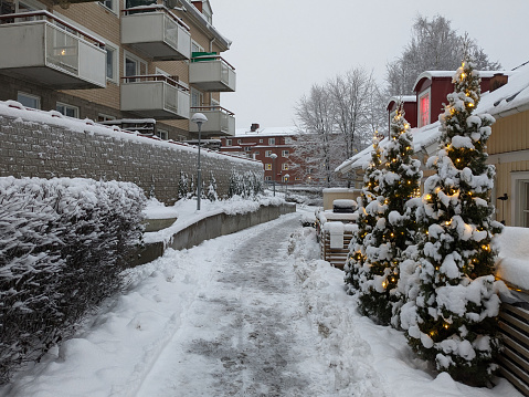 A walkway admist buildings at winter