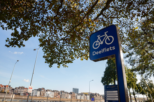 Picture of a sign indicating Deelfiets, meaning, bicycle sharing, on a station in Maastricht, Netherlands.
