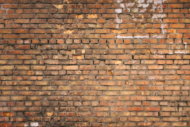 Dilapidated yellow-red brick wall.  Can be used as a background or poster.