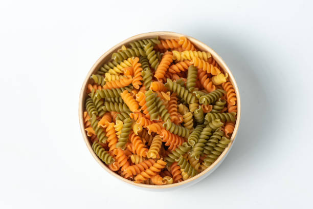 istock Three colors pasta in a bowl, uncooked 1883442884