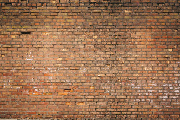 istock Dilapidated yellow-red brick wall.  Can be used as a background or poster. 1883458835