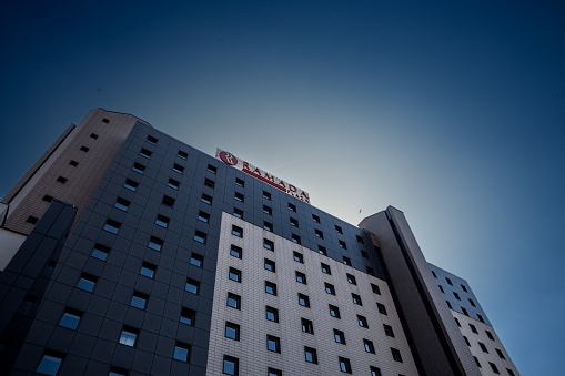 Picture of a sign with the logo of Ramada taken on their main hotel for Bucharest, Turkey. Ramada is a large American multinational hotel chain owned by Wyndham Hotels and Resorts.