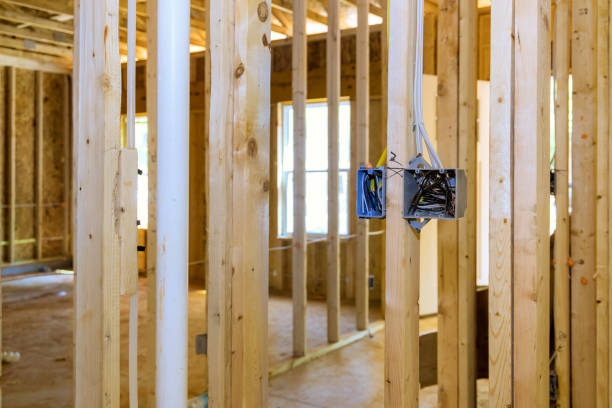 istock A plastic electrical switchbox is mounted to wooden frame beams on wall with wires running through it 1883513069
