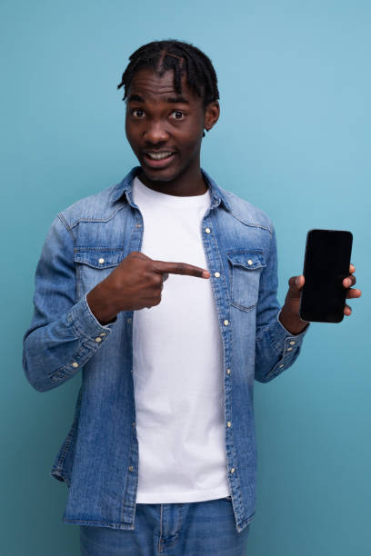 istock smiling african man with black dreadlocks using smartphone 1883521862