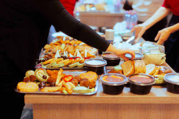 istock Hands Taking Food from a Table at a Swedish Buffet Party 1883525399