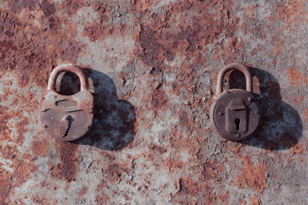 istock Vintage steel lock. Locked padlock on rusty metal background. 1883561131