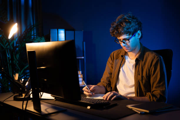 istock Young businessman writing design thinking on paper for new project. Gusher. 1883759825