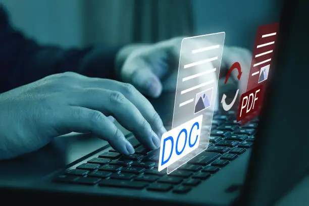 Photo of Convert PDF files with online programs. Users convert document files on a platform using an internet connection at desks.
