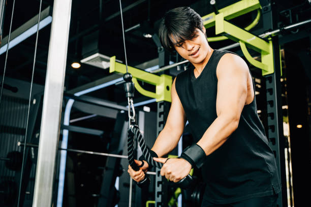 istock Young man performing cable triceps pulldowns to build muscle and strength 1883781001