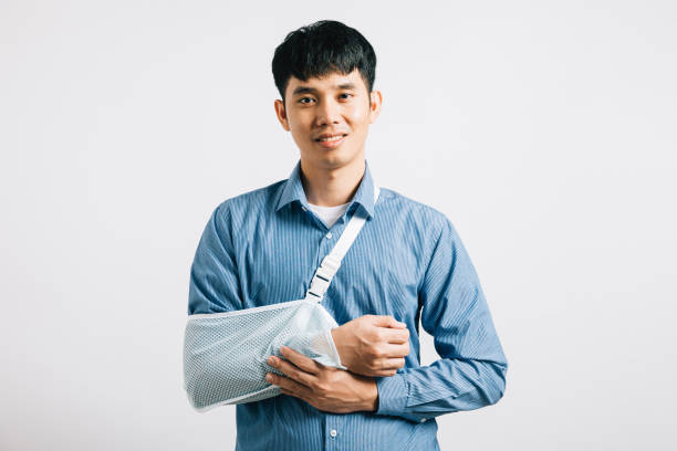 istock happy Asian man wears arm support in studio shot isolated 1883781243