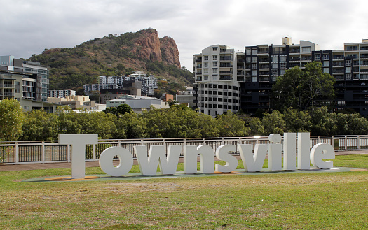 Townsville, Queensland, Australia - July 30, 2023: Townsville sign with buildings and Castle Hill in the background