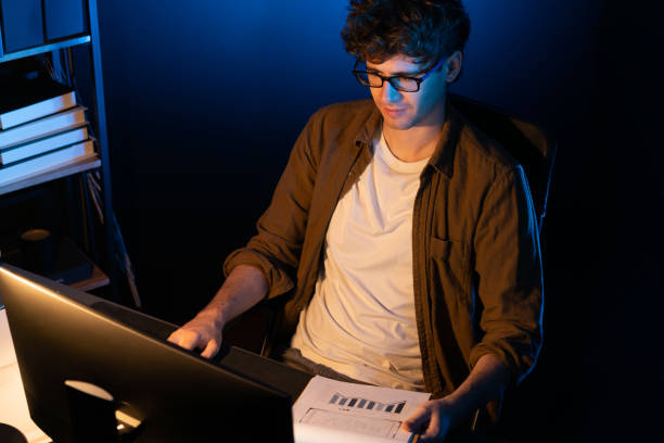 istock Young businessman reading design thinking on paper for new project. Gusher. 1883820497