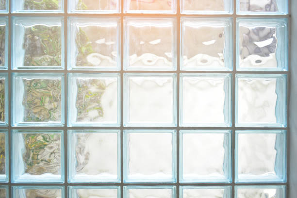 istock close up glass block wall with golden natural light background, interior design 1883825049