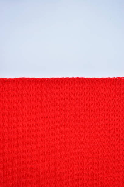 istock red wool knitted yarn texture, woolen fabric on white background 1883825572