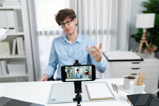 istock Influencer using phone streaming online focusing phone with portrait. Gusher. 1883828193