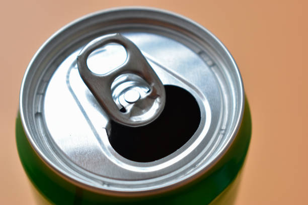 istock aluminum green drink cans on orange background, open cold fresh beverage 1883831246