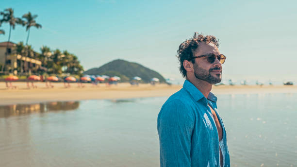 istock Man looking at the horizon on the beach 1883841145