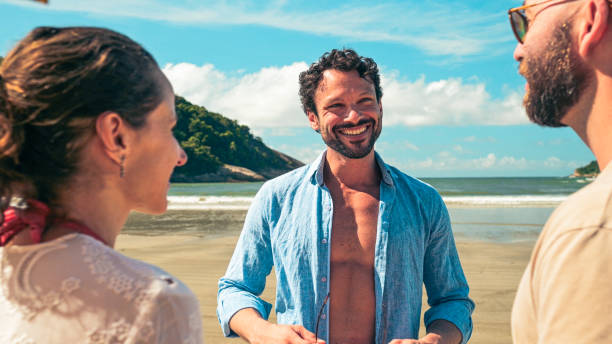 istock Friends enjoying and laughing at the beach 1883841497