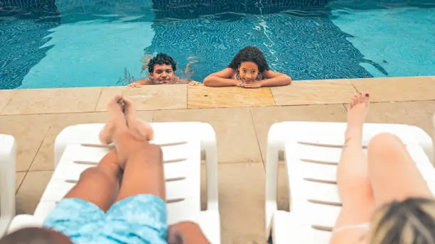 Parents talking to their children in the pool