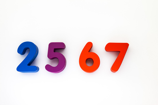 Image of colorful wooden block letters that convey the meaning of the upcoming 2567 Buddhist New Year on a white background.