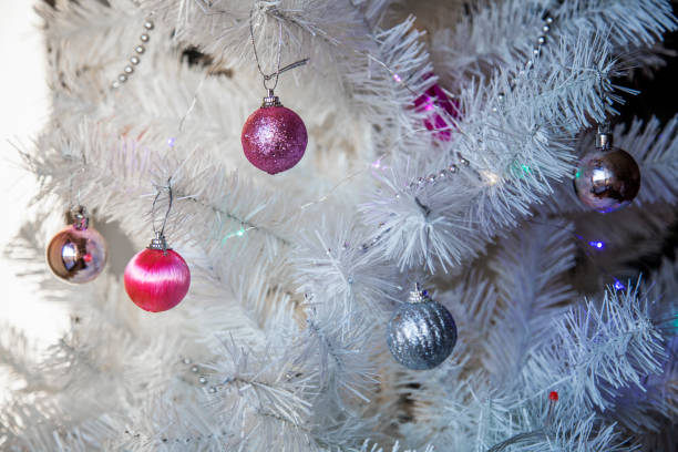 istock christmas star decoration on a white christmas tree close-up 1884131738