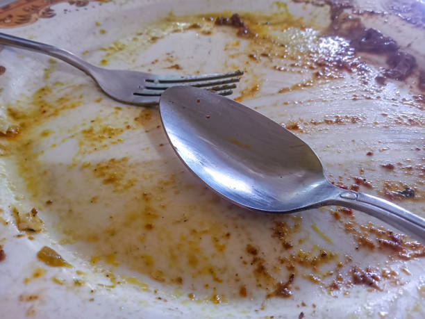 istock spoons and forks left on plates with leftover food 1884154123