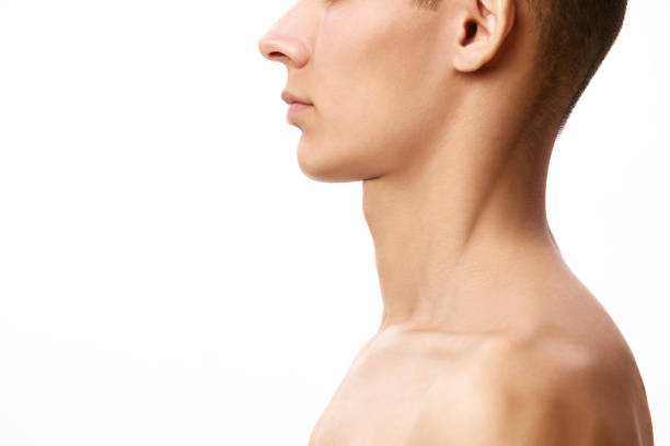 istock Cropped image of young man's face with neck against white studio background. Face shape correction, double chin 1884156702