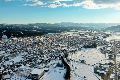 Drone photography: Scenery of a residential area in a rural town in the evening covered with pure white snow