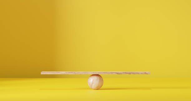 istock Wooden scales on a yellow background. 1884191095