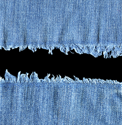 Old jeans denim background isolated on black.