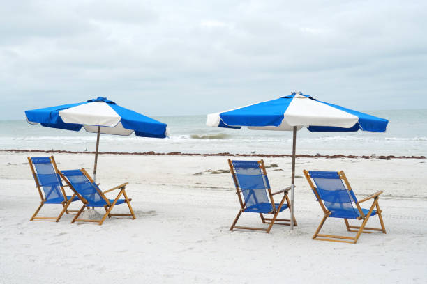 istock beach chair and umbrella in a row on the white sand beach 1884234708