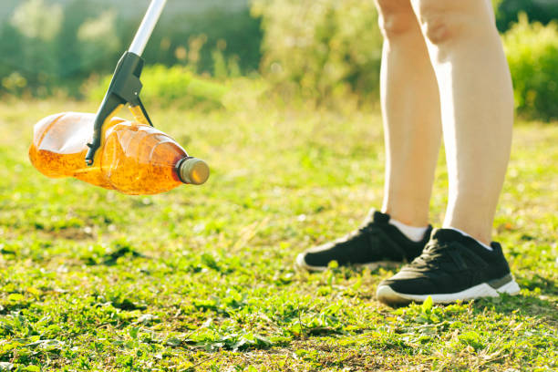 istock Woman picking the plastic bottle by the garbage picking tool 1884239397