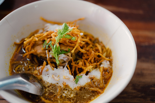 Khao Soi Recipe, Northern Style Curry Noodle Soup in a white bowl. Local Thai food