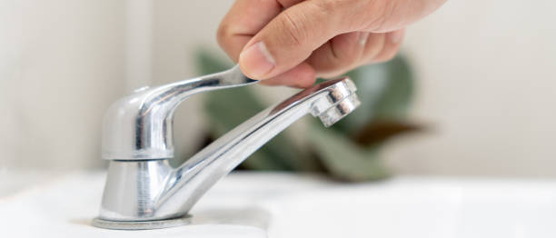 istock Save water. Man keeps turning off the running water in the bathroom to protect environment. Greening planet, reduce global warming, Save world, life, future, risk energy, crisis , water day. 1884268195
