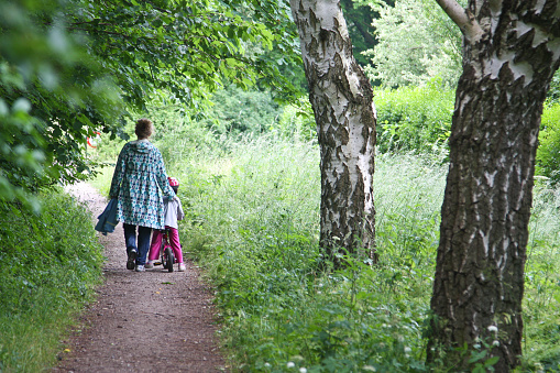 Mother and daughter going on a path in denmark