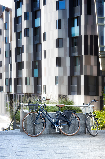 City ​​bikes in front of a modern apartment building in Milan, Italy