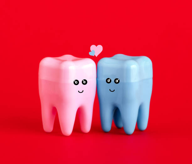 istock Cute blue and pink tooth on red background. St Valentine's day card. 1884363941