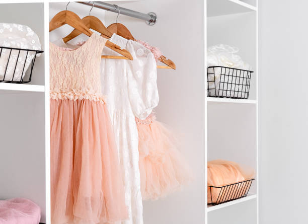 istock White dressing room with elegant lush dresses. Storage organization concept. 1884364453