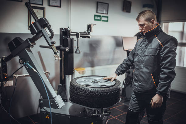 istock Mechanic putting tire on wheel rim 1884370746