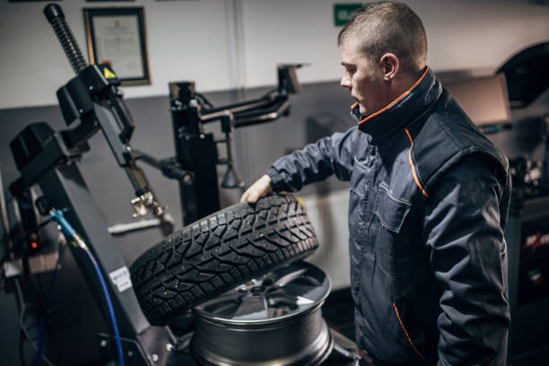 istock Mechanic putting tire on wheel rim 1884373045